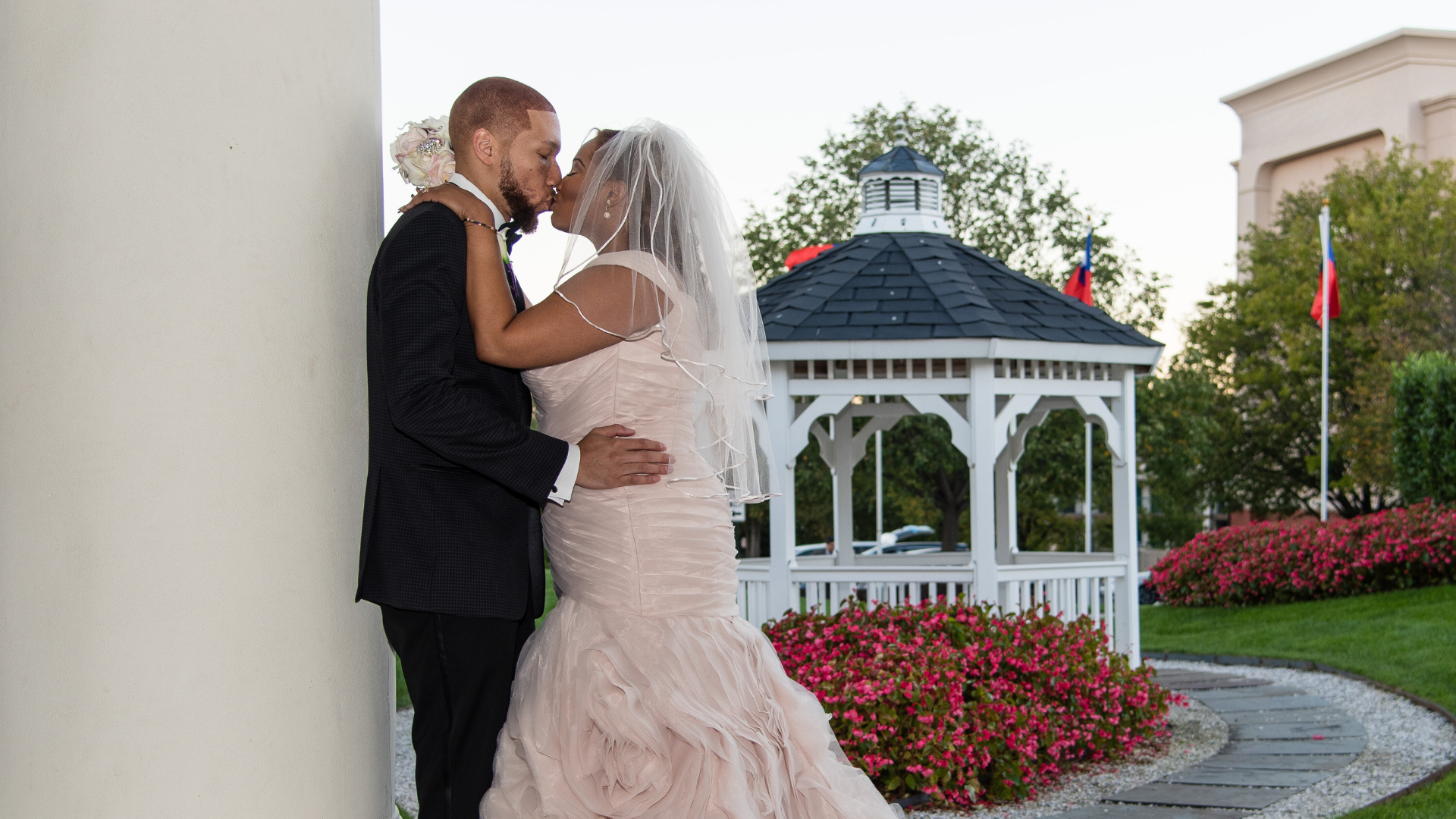 Bride and Groom sharing a kiss in front of the gazebo,