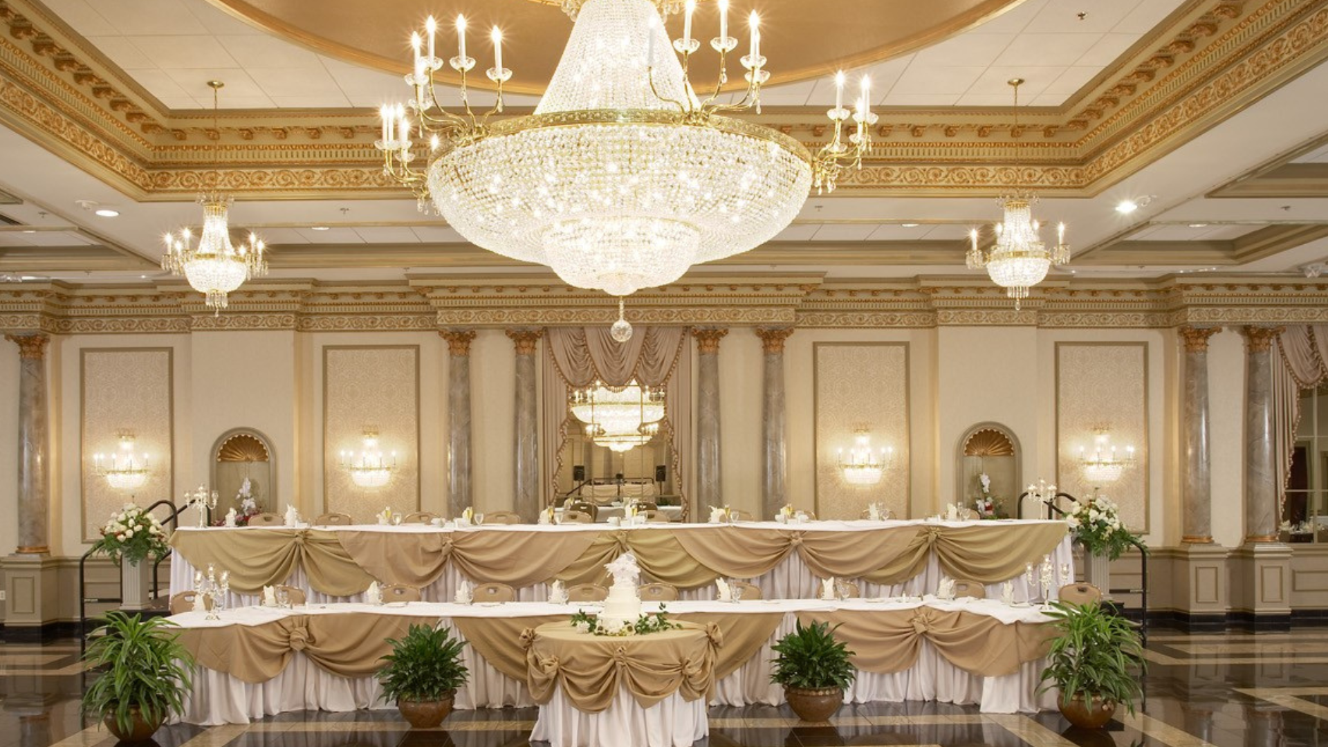 Wedding reception set-up with 2 tiered head table.